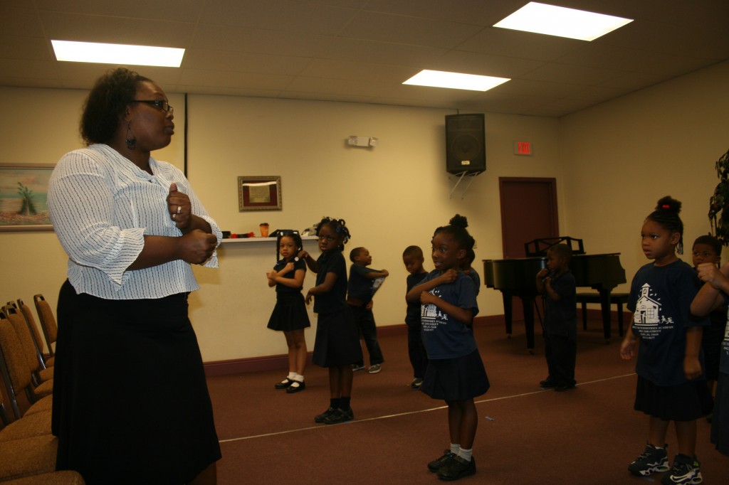 Bible Truth Ministries Academy teacher Tiffany Smith-Sutton guides kindergartners through a performance they will give during their graduation. The school's founders plan to focus more on early education, giving kids a love for learning as early as possible.