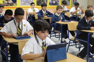 In this 2012 file photo, students at Miami's Belen Jesuit Preparatory School Pads during a Spanish class.