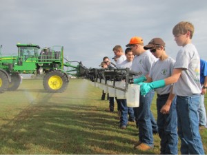 Glades Day School students experiment with spreading fertilizer.