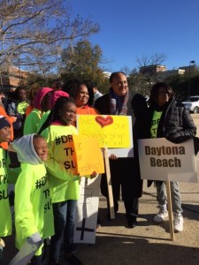 Martin Luther King, III joins scholarship supporters before a march near the Florida State Capitol.