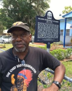 Former student Ozell Ward stands in front of a historical marker of the Milner-Rosenwald Academy in Mount Dora, Fla.